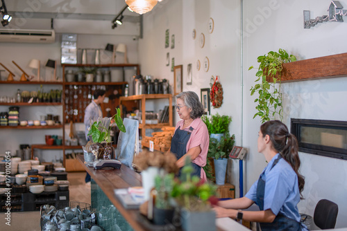 Mother, son and daughter are working at their DIY store.