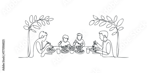 Family eating meal together outside under trees