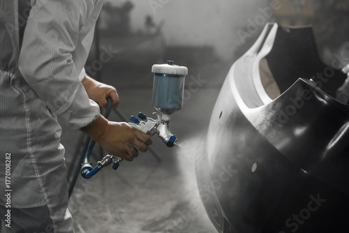 Application of primer before the main spray painting of the car bumper. 