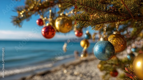 Christmas tree ornaments hanging on beach against ocean, copy space