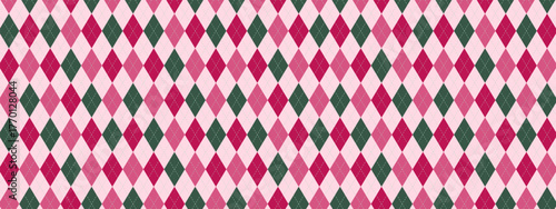 Pink argyle pattern background with green diamond shapes creating plaid texture. Repeating rhombus, diagonal lines, geometric blocks form classic design. Vector cozy seamless wallpaper.