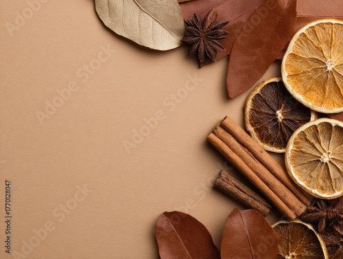 Fototapeta Naklejka Na Ścianę i Meble -  Flat lay composition with dried oranges, cinnamon sticks, bay leaves and star anise on warm beige background perfect for autumn recipes, cozy kitchen designs and seasonal food backgrounds