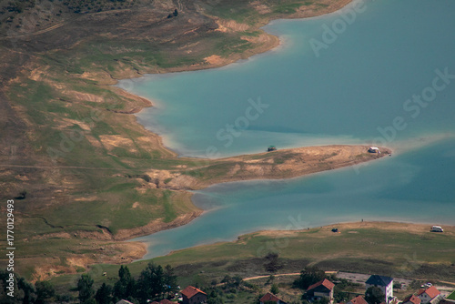 Фотография Serene turquoise lake embraces isolated islet, invoking reflections of seclusion