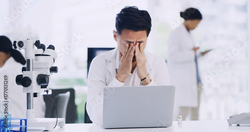 Man, scientist or laptop with stress in laboratory for forensic research, fail or mistake. Male person, healthcare worker or science with headache on computer for strain, pressure or medical deadline