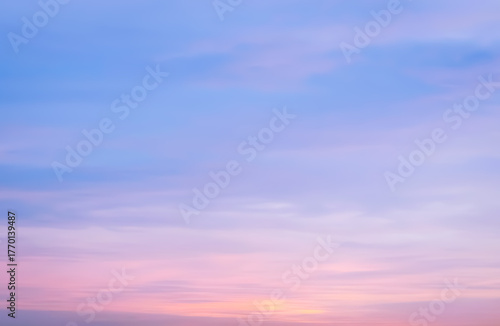 A dreamy canvas of pastel clouds drifts across the sky, softly kissed by the hues of twilight.