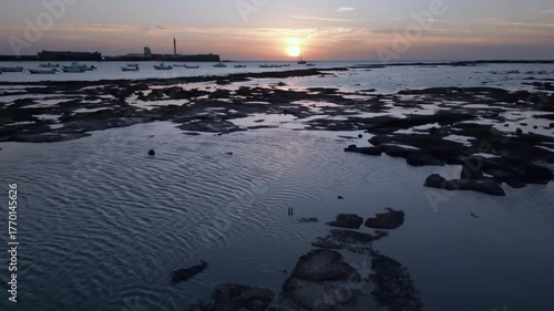 Boats at low tide on the seaside, breathtaking summer sunset landscape.