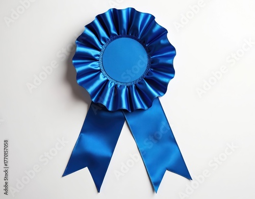 Shiny blue ribbon rosette on white background. Award for success, achievement or victory. Isolated studio shot of satin cockade prize with space. Symbol of quality or excellence.