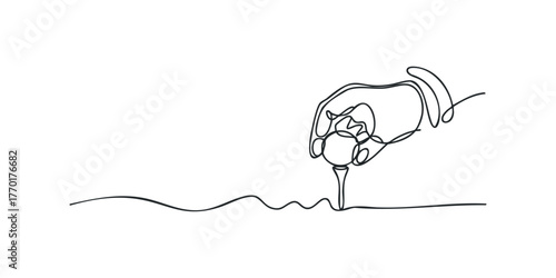 Hand placing golf ball on tee