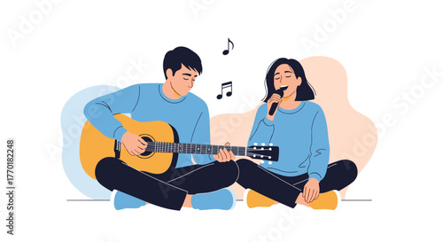 A man plays an acoustic guitar while a woman sings into a microphone, performing music together in a joyful duet.