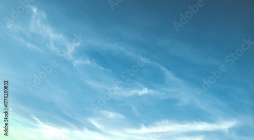 the sky is clear blue with fluffy white clouds, the sky is very bright, and the sun shines.