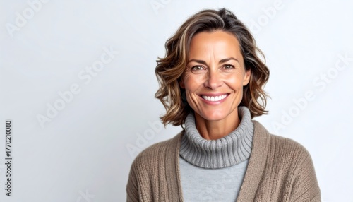 Smiling mature woman portrait on white.