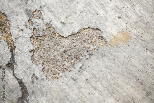 The textured cement of footpath with shape of heart,conceptual abstract background