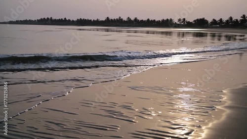 Scenic view of waves rushing at sandy beach against sky during sunset. beach at sunset