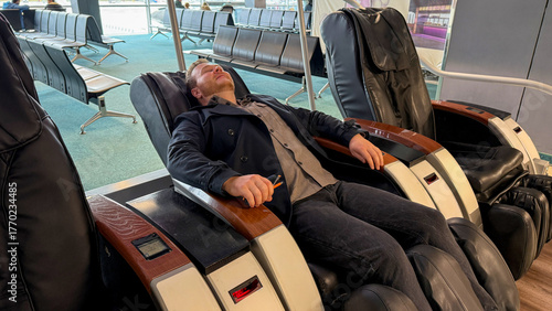 A Caucasian male lounges blissfully in a massage chair at the airport, summoning tranquility amid travel chaos, perfect for World Sleep Day or Slow Living celebrations