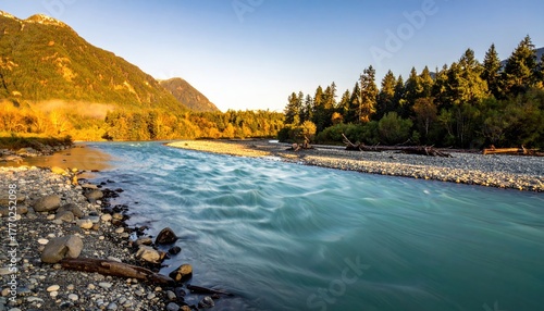 Mountain river flowing through a valley at dawn