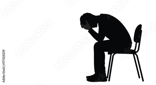 A solitary silhouette of a person sitting on a chair, head bowed and hands covering face, conveying deep sadness or distress.