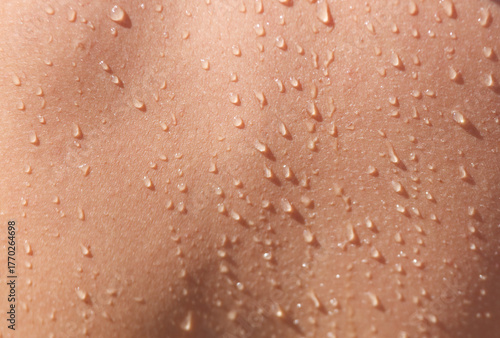 A person's back is wet with water