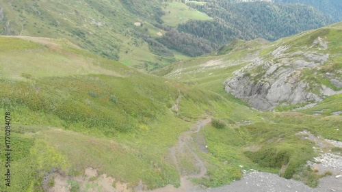 Magnificent mountain landscape, drone video. Mountain valley with lush green grass, unity with nature