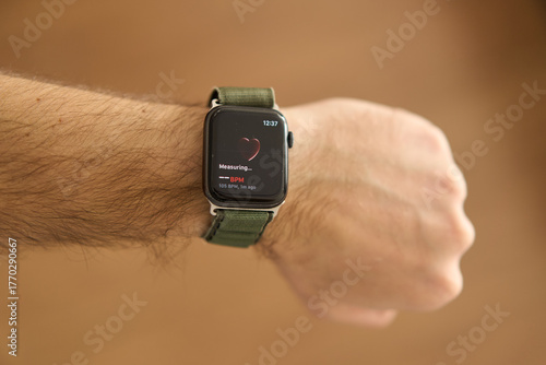 A square smartwatch on a man's hand close up. Heart rate measurement on watch. High quality photo