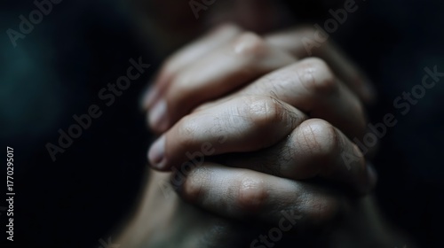 Close up of human hands clasped in prayer conveying deep contemplation and solemn emotion