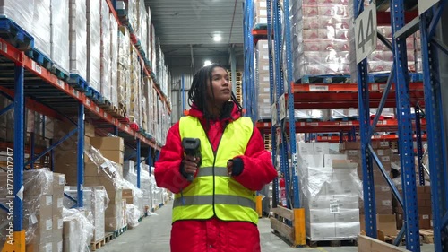 Female warehouse worker scanning barcodes in cold storage facility