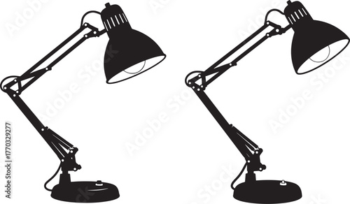 Two identical black desk lamps in silhouette