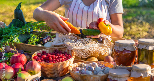 A woman farmer sells fruits and vegetables at a farmers market. Selective focus.