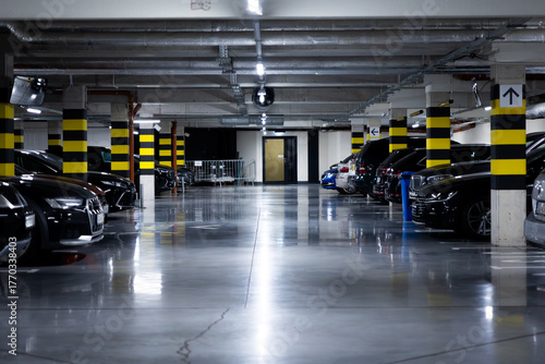 Interior of a modern underground parking lot full of cars