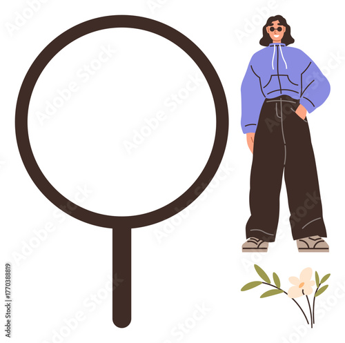 Woman in oversized hoodie and wide-leg jeans stands confidently next to a large magnifying glass and delicate flowers. Ideal for fashion, individuality, confidence, focus, discovery, exploration