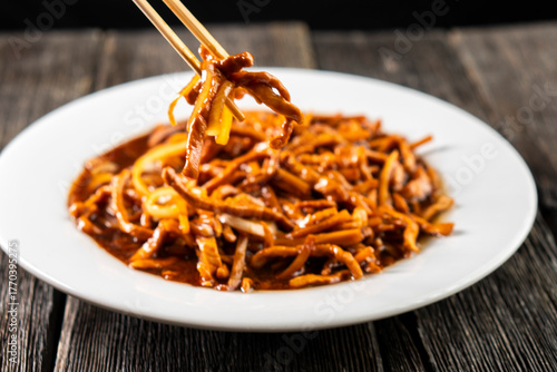 Hoisin chicken pancakes on a wooden background. Chinese cuisine. Asian food. Food concept