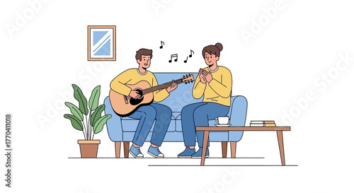 A young man in a yellow sweater plays an acoustic guitar for a woman clapping along on a blue sofa.