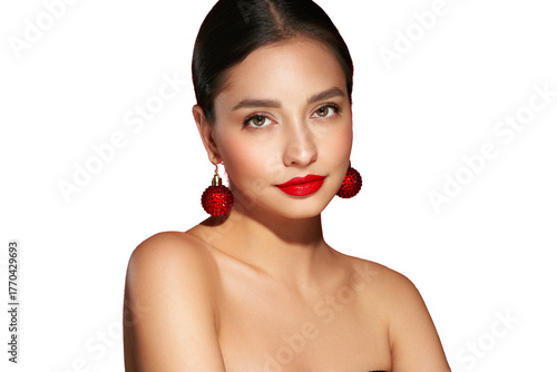 Portrait of beautiful young woman on transparent background, red lipstick and festive makeup, Christmas toy earrings, shiny glowing skin, Winter holidays concept
