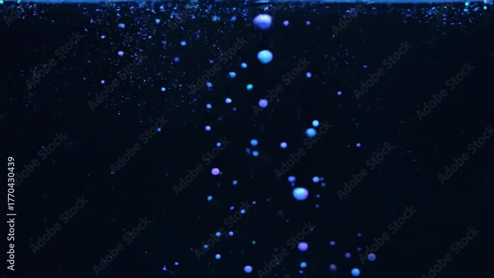 Numerous neon glowing spherical particles slowly rising through a clear liquid in a dark environment creating a soft, ethereal ascent conceptual, fantasy, background