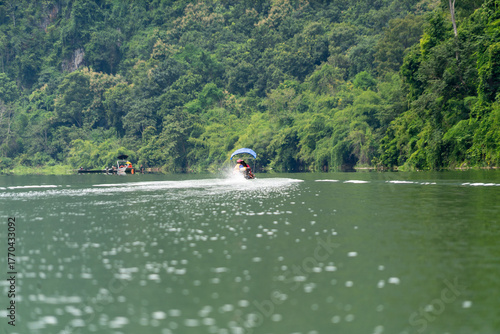 A man is riding a jet ski on a lake