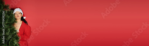 Φωτογραφία Celebrating Christmas with joy and style in festive red attire and a santa hat