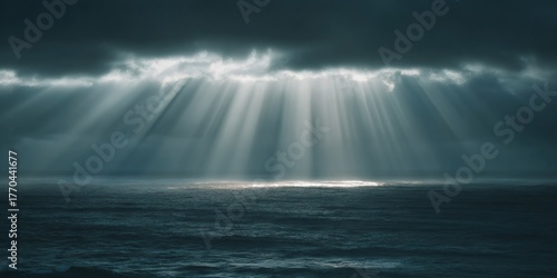 Golden sun rays breaking through dark storm clouds over deep ocean water, providing hope and a dramatic mood