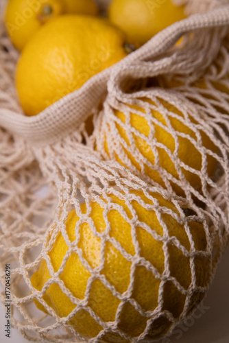 Trendy Net Bag with Yellow Lemons – Minimal Fashion Flat Lay on White Background