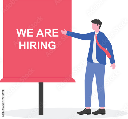 A businessman arranging the text WE ARE HIRING,

