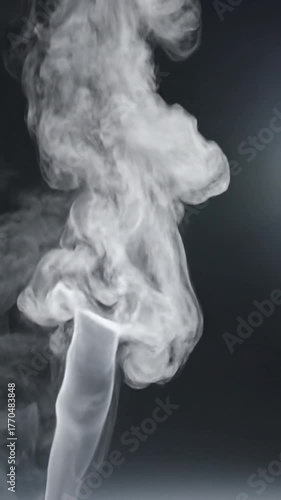 Ethereal white smoke drifts against a dark gray background
