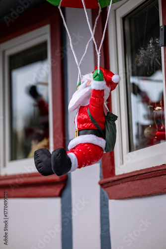 Santa Claus jumped with a parachute out of the window. Christmas miracles. New Year.