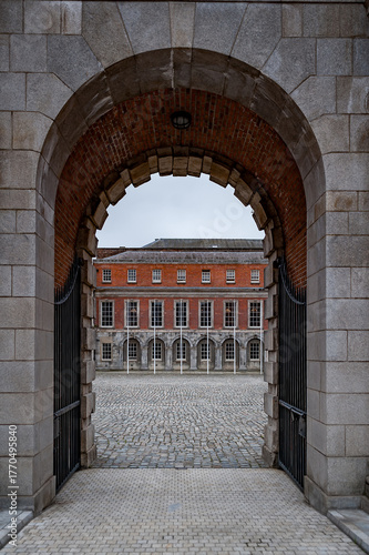 Historic Cork Hill Gate, the main entrance to Dublin Castle, one of the most iconic landmarks in Dublin, Ireland. Stone archway and castle walls representing Irish history and architecture.