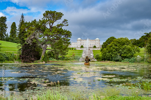 Powerscourt Gardens, view of the Triton Lake fountain and Powerscourt Estat . Ireland.
