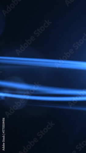 Blue light streaks and flares on dark background, abstract, futuristic