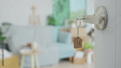 Moving house, relocation. The key was inserted into the door of the new house, inside the room was a cardboard box containing personal belongings and furniture. move in the apartment or condominium