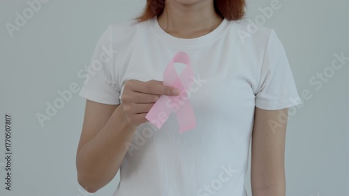 Woman hold pink ribbon breast cancer awareness. Female health check consciousness. international Women Day and World Cancer Day. sign cancer, Symbolic, health care, support patients, timely diagnosis