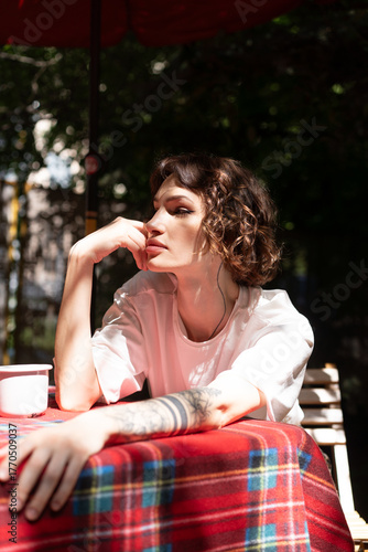 Young beautiful woman posing in white clothes in summer outside