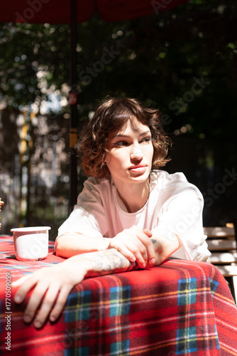 Young beautiful woman posing in white clothes in summer outside
