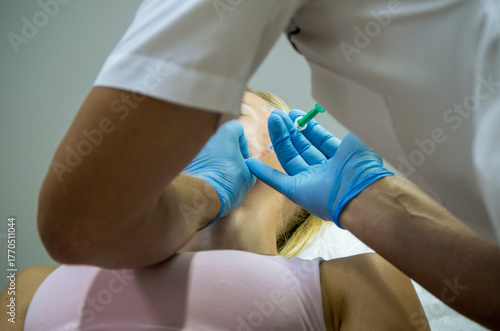 doctor gives beauty injections to a woman