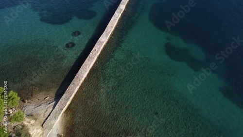 water polo field by the sea, by the concrete jetty, sunny day, summer, calm sea, view from a drone