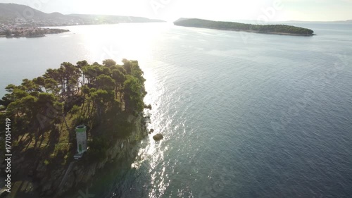 small uninhabited island in the Adriatic Sea, Croatia, shot by a drone, early autumn, late morning, the camera is stationary